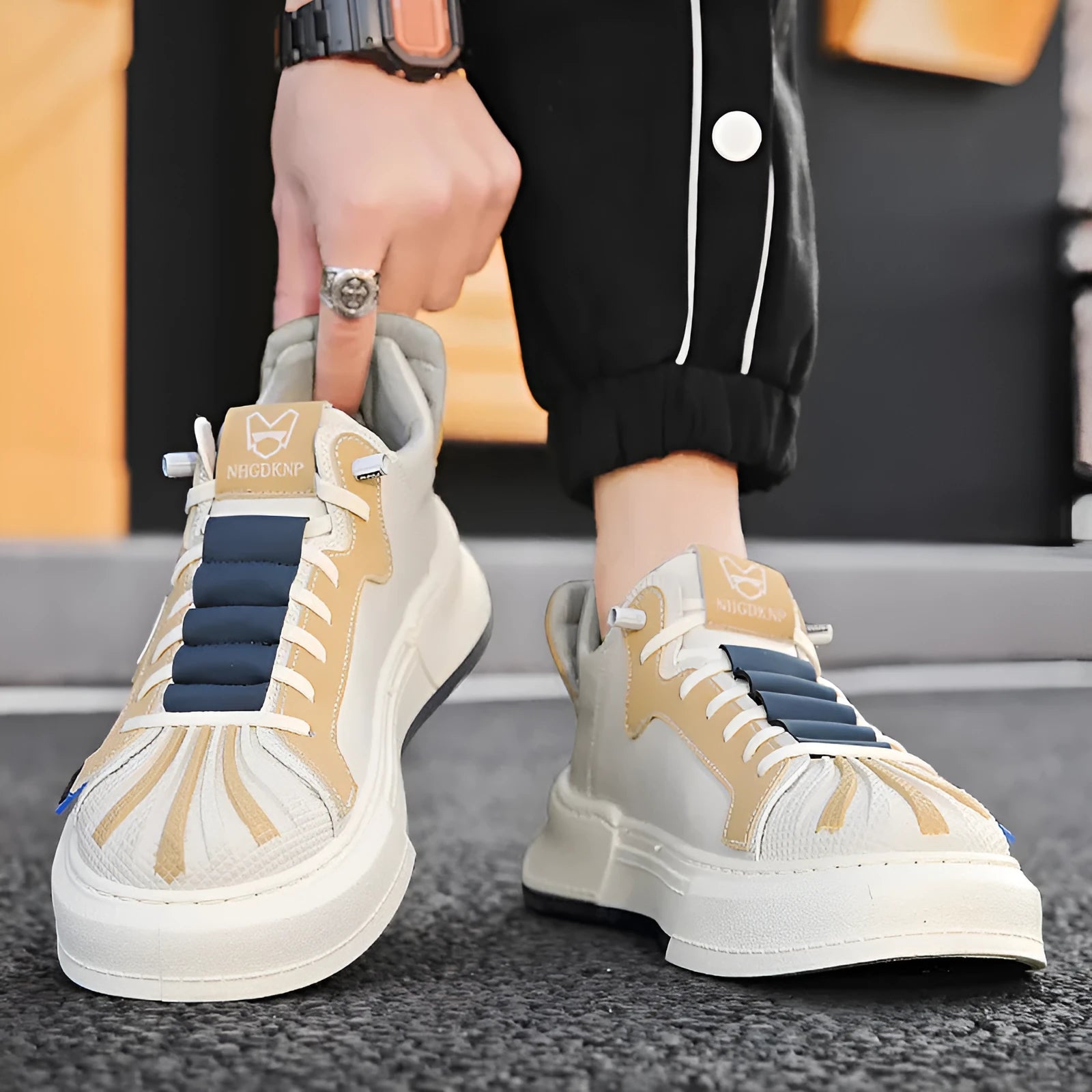 Men's beige low-top sneakers with elastic band closure and leather stitch detail on microfiber upper