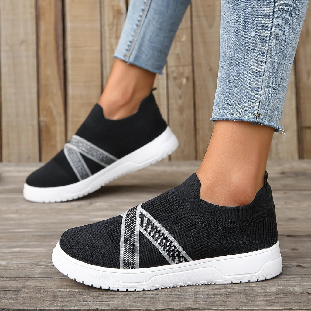 Women's black flat bottom flyknit mesh shoes with tassel detail, round toe, and rubber sole