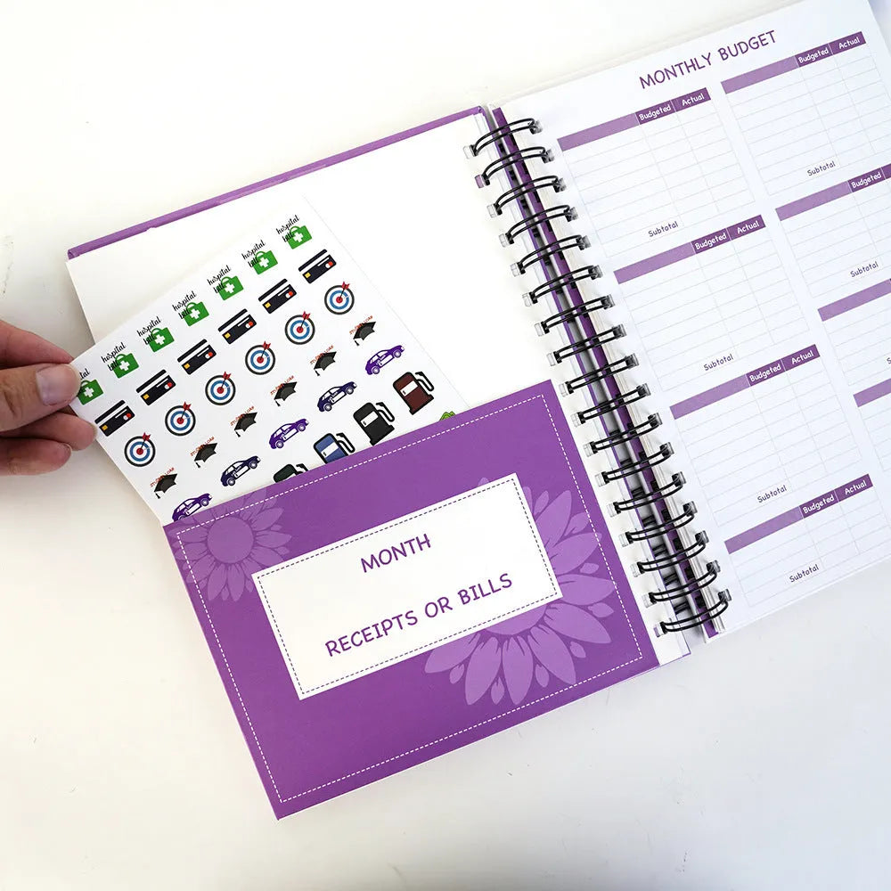 J12 purple coil-bound budget notebook with stickers and paper clips for financial planning