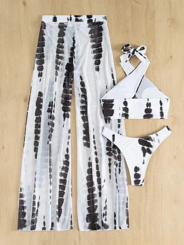 Women's three-piece printed swimsuit set with bikini top, pants, and mesh trousers.