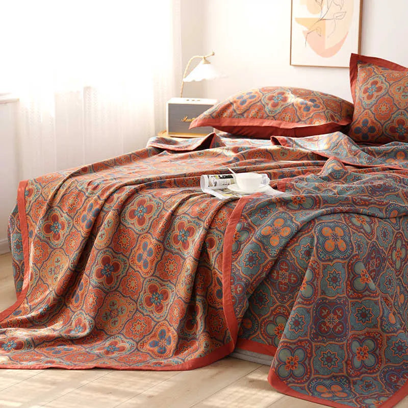 Cotton gauze three-piece bedding set with botanical flower pattern showing blanket and two matching pillowcases