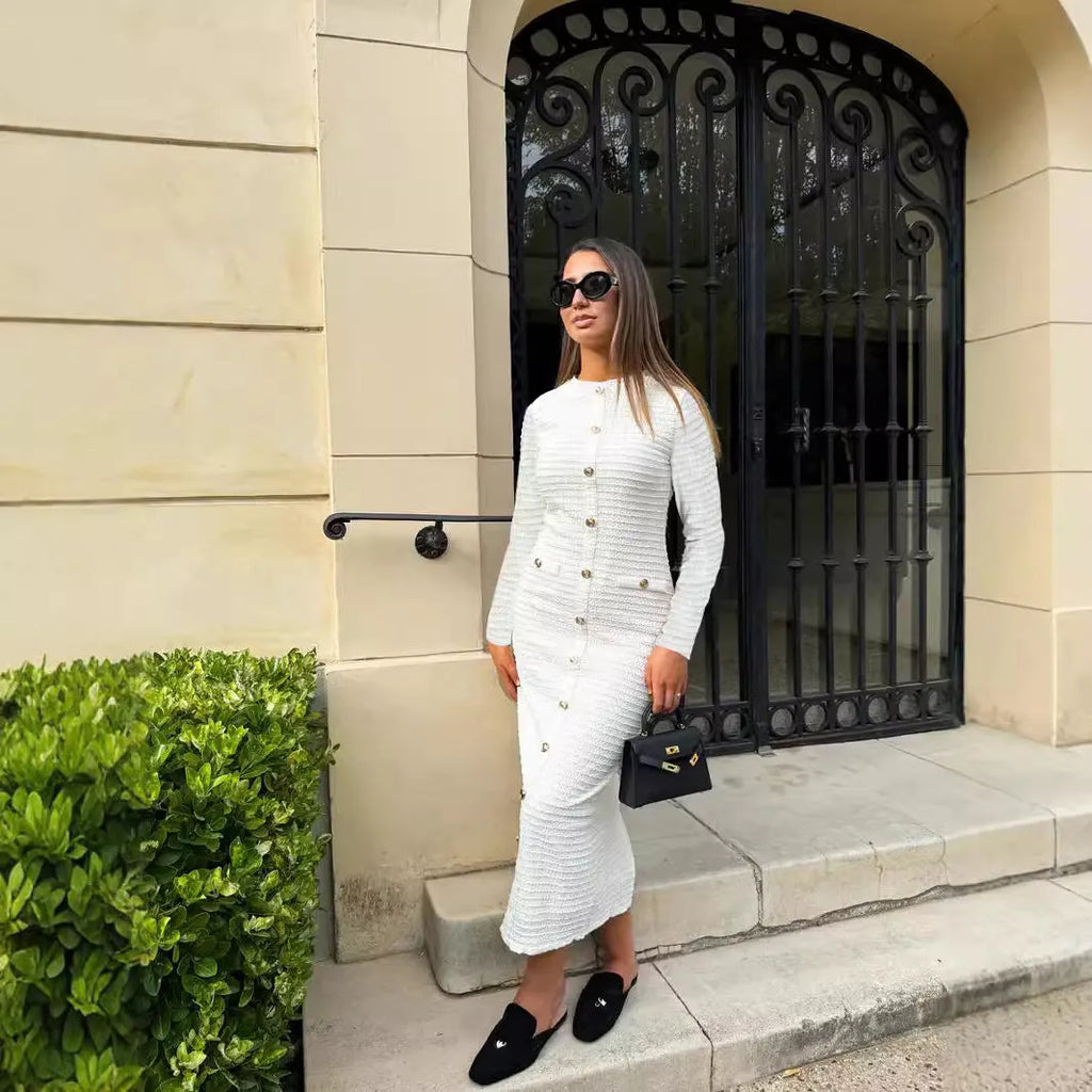 Black and white French retro slim fit knitted long-sleeved dress with button detail.