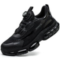 Lightweight black safety work shoes with a steel toe cap and breathable flyweave upper on a work floor.