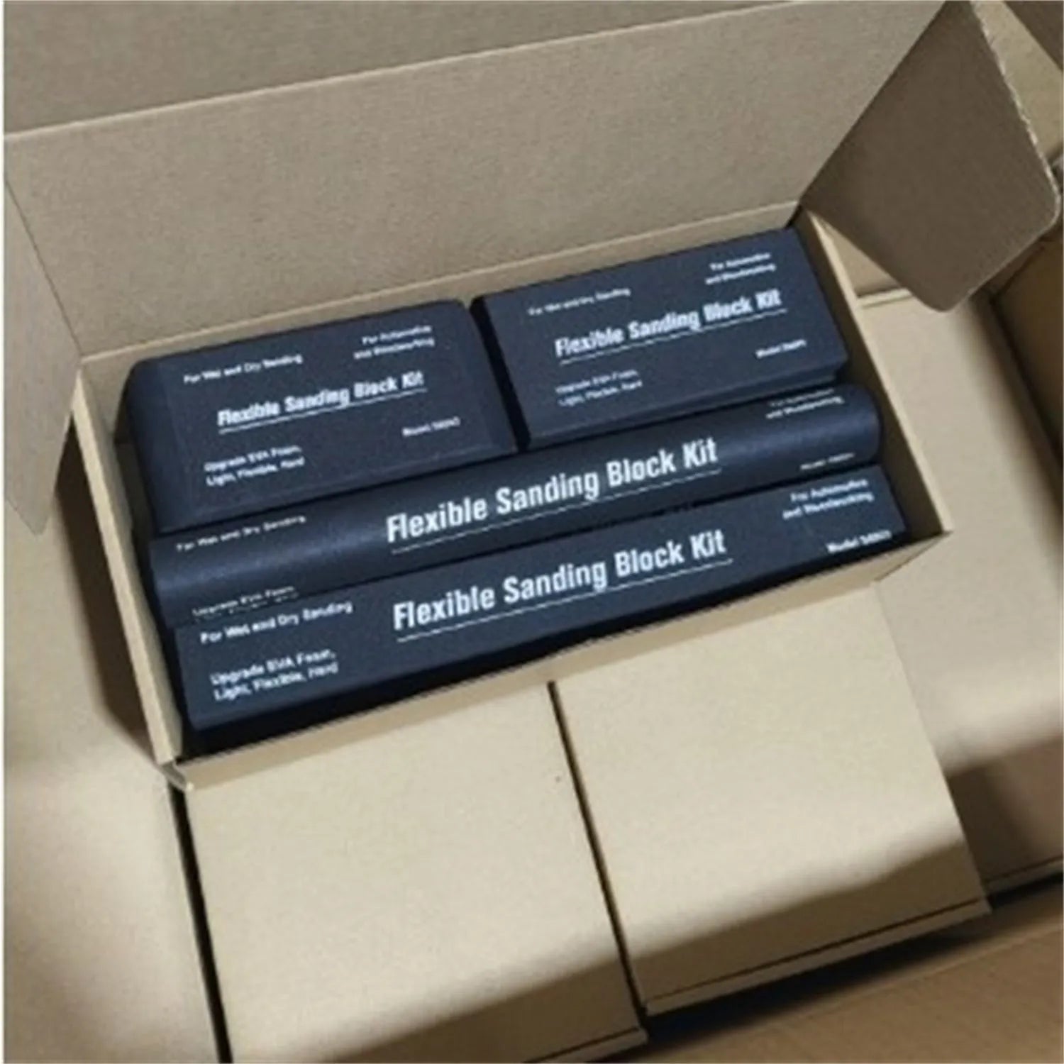 Set of seven black frosted metal alignment blocks for workshop use.