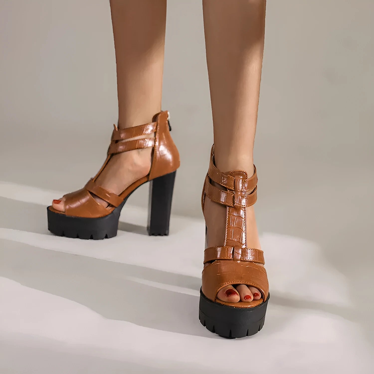 Platform high heel sandals in black with round toe, back zipper, and rubber sole