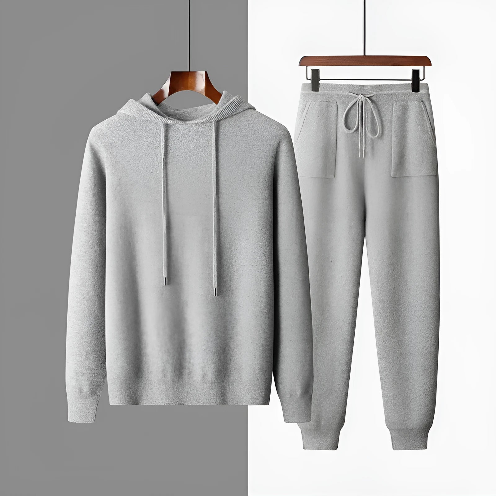 Men's light gray cashmere hooded sweatshirt and matching track pants laid flat.