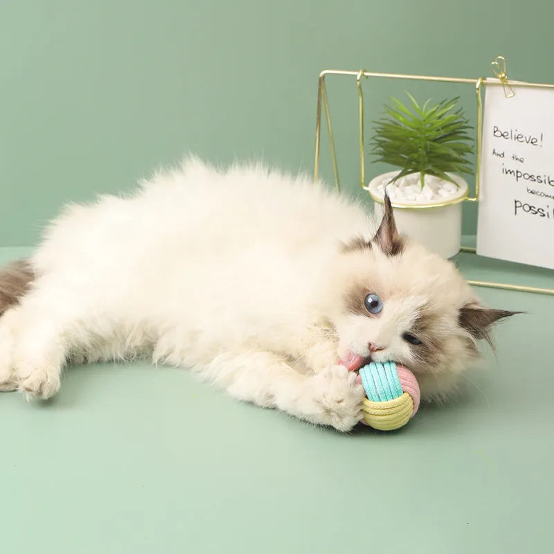 Handmade blue powder and green cotton plush ball cat toy for play and teeth grinding.