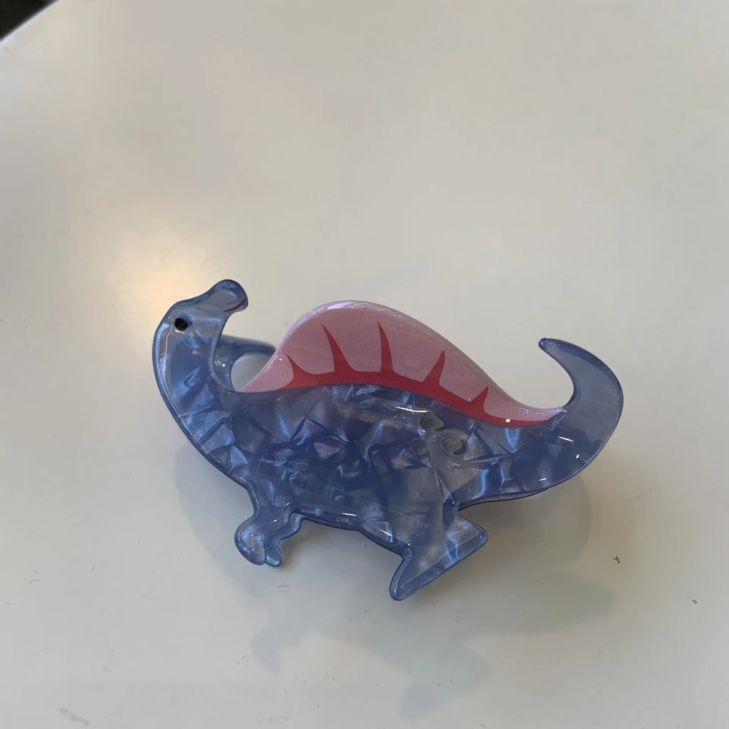 Dinosaur acrylic jaw clip hairpin in six colours including pink pterosaur and green stegosaurus on neutral background