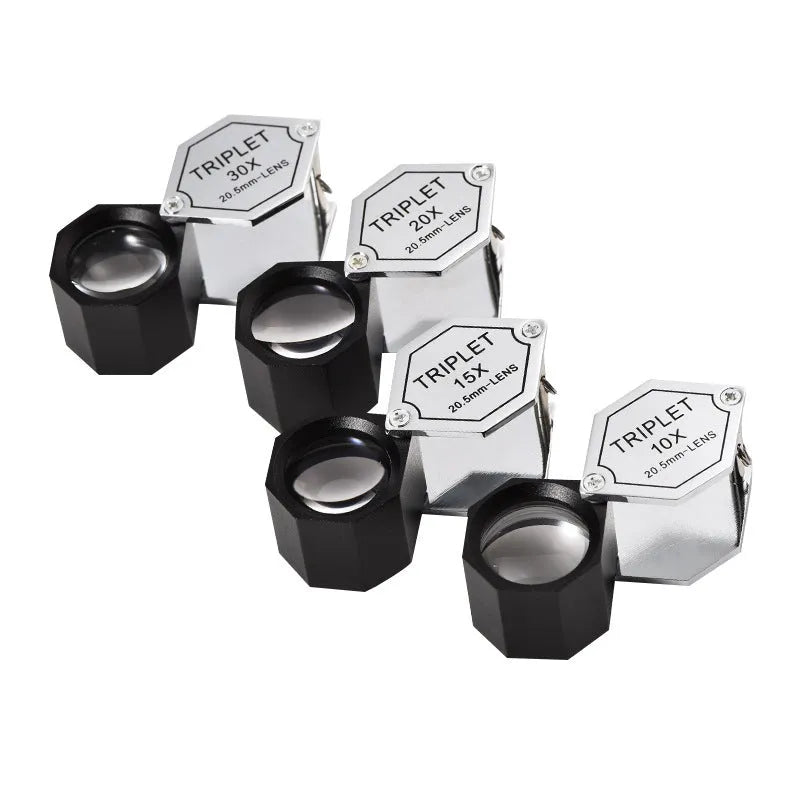 Handheld portable magnifying glass with metal body for jewellery and coin identification.