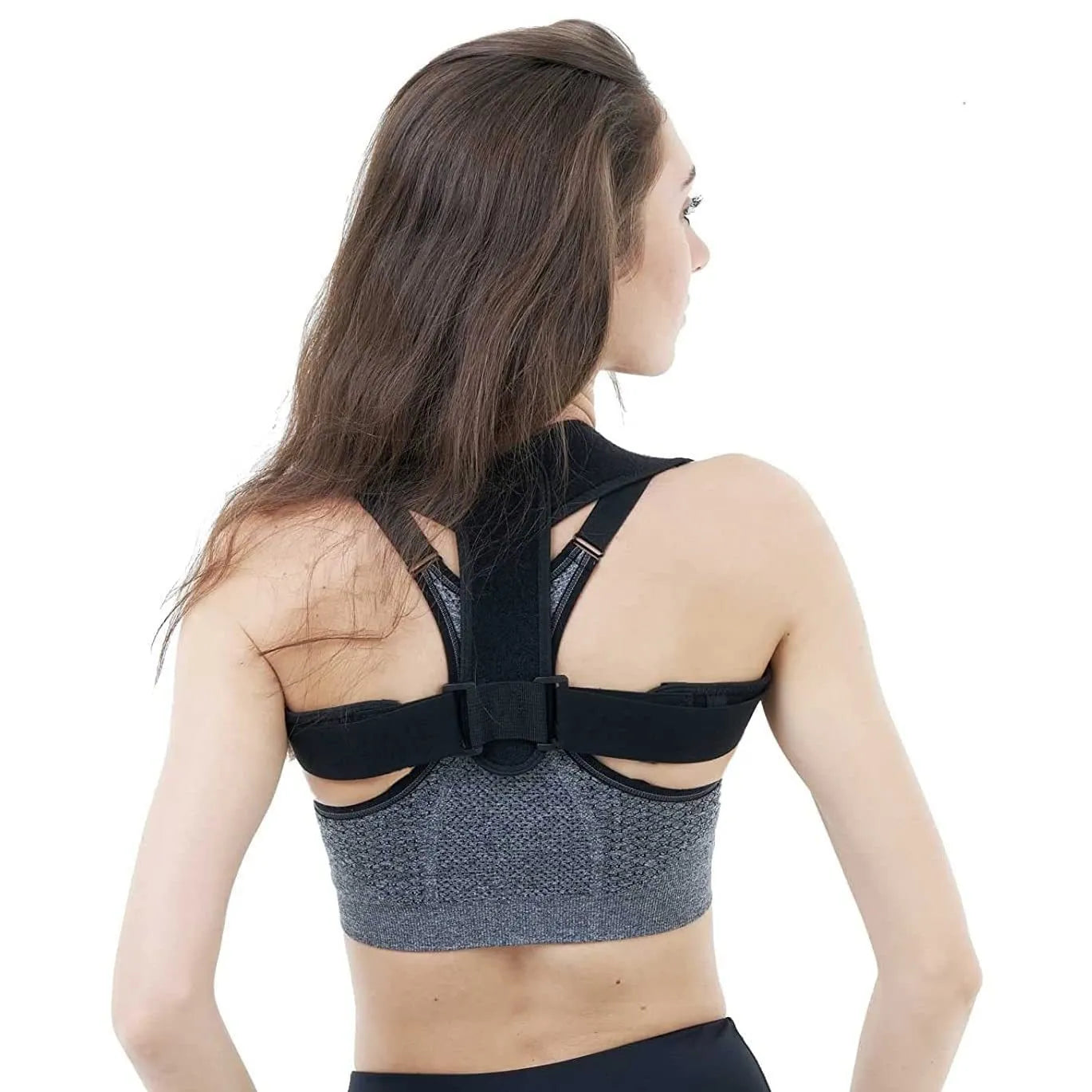 Black adjustable posture correction strap laid flat, showing its breathable material and adjustment mechanism.