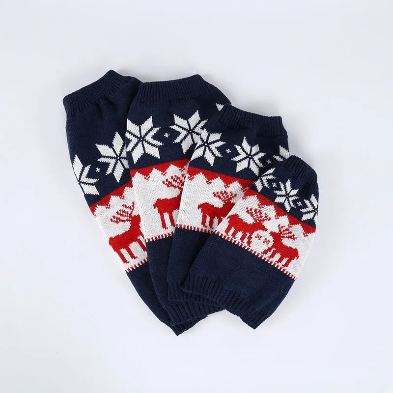 Navy blue knitted Christmas sweater for a dog on a hanger.