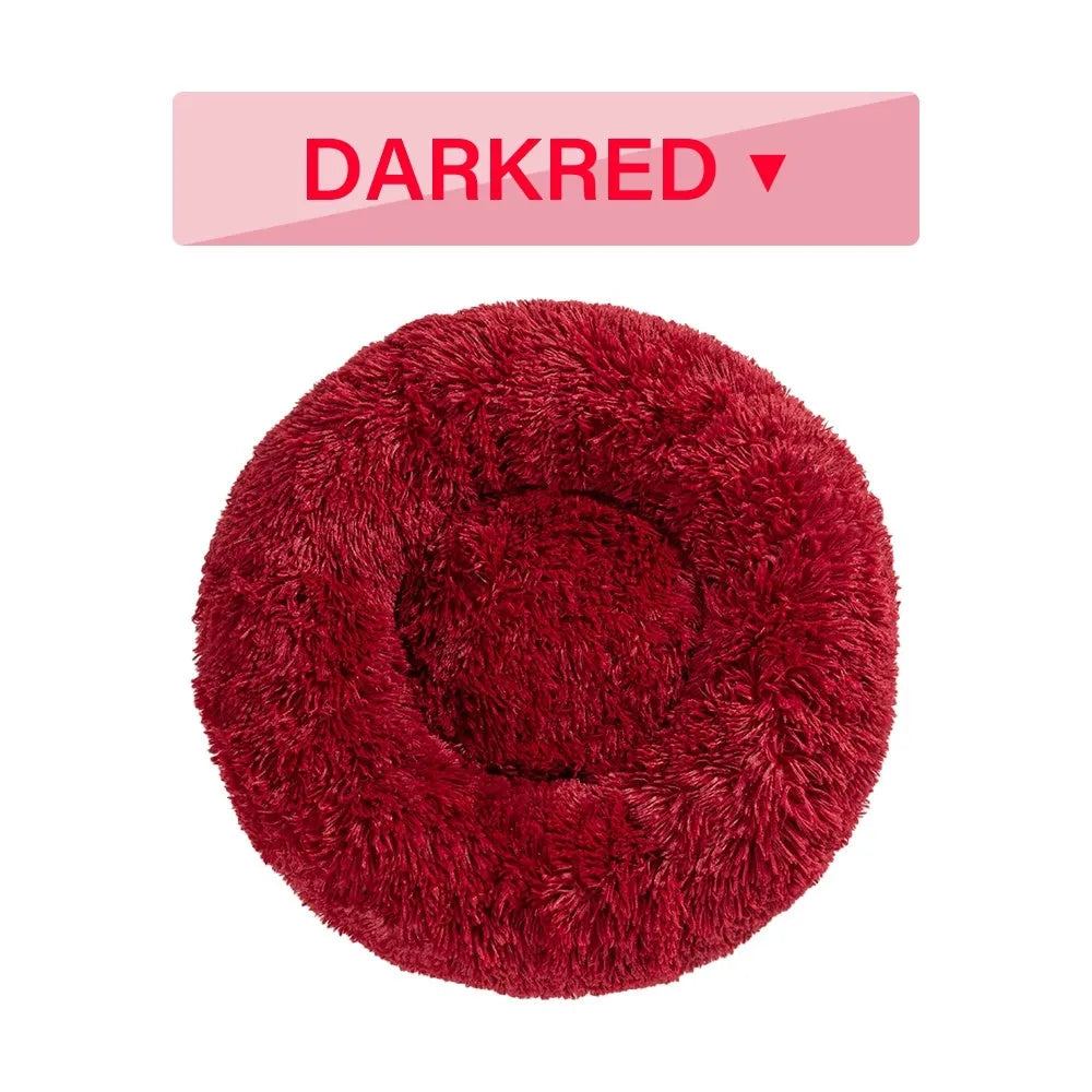 Fluffy donut-shaped dog bed in long plush fabric, shown in a light grey colour without a zipper.