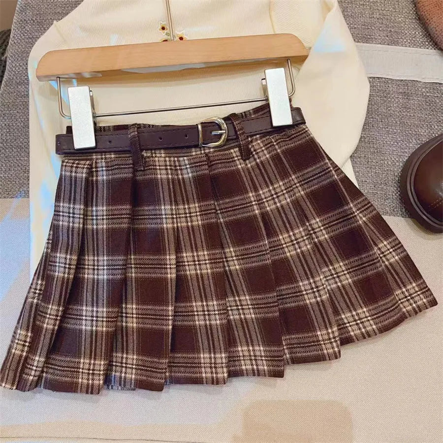 Girls plaid pleated A-line skirt in cotton blend, shown on hanger.
