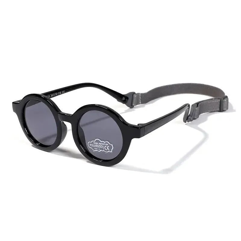 Round frame polarised sunglasses for toddlers aged 0-3 years with UV400 protection, shown in multiple colour options.