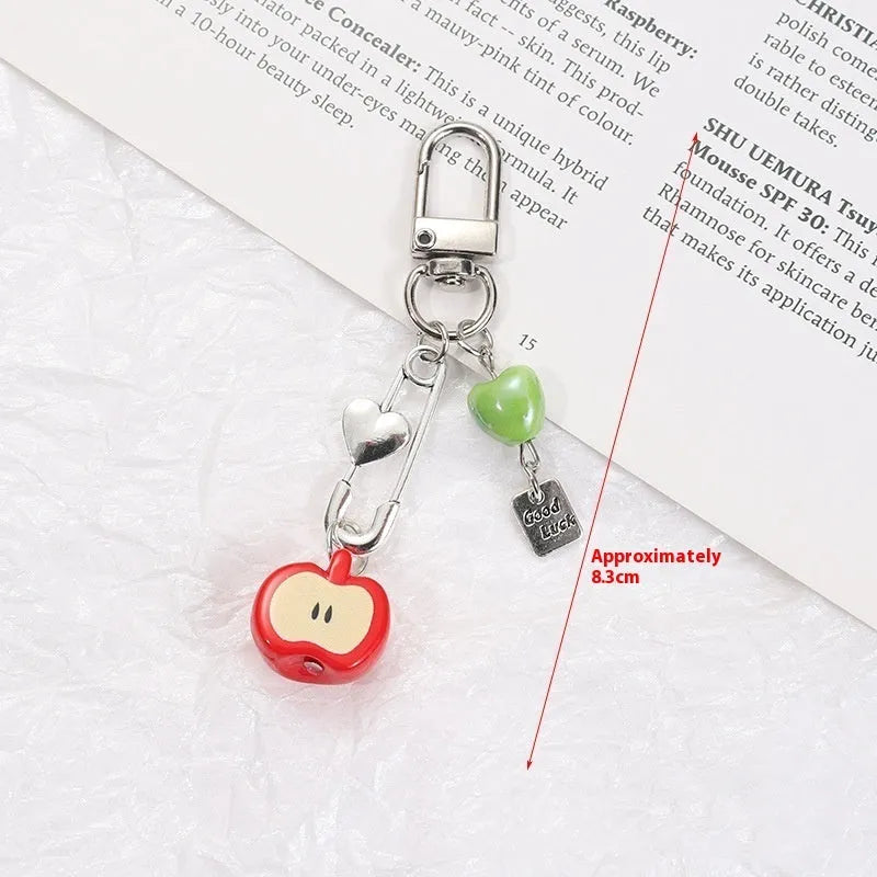 Fruit-shaped mobile phone bag pendant keychain in plastic resin with apple and strawberry design, half-handmade finish, multiple colour options
