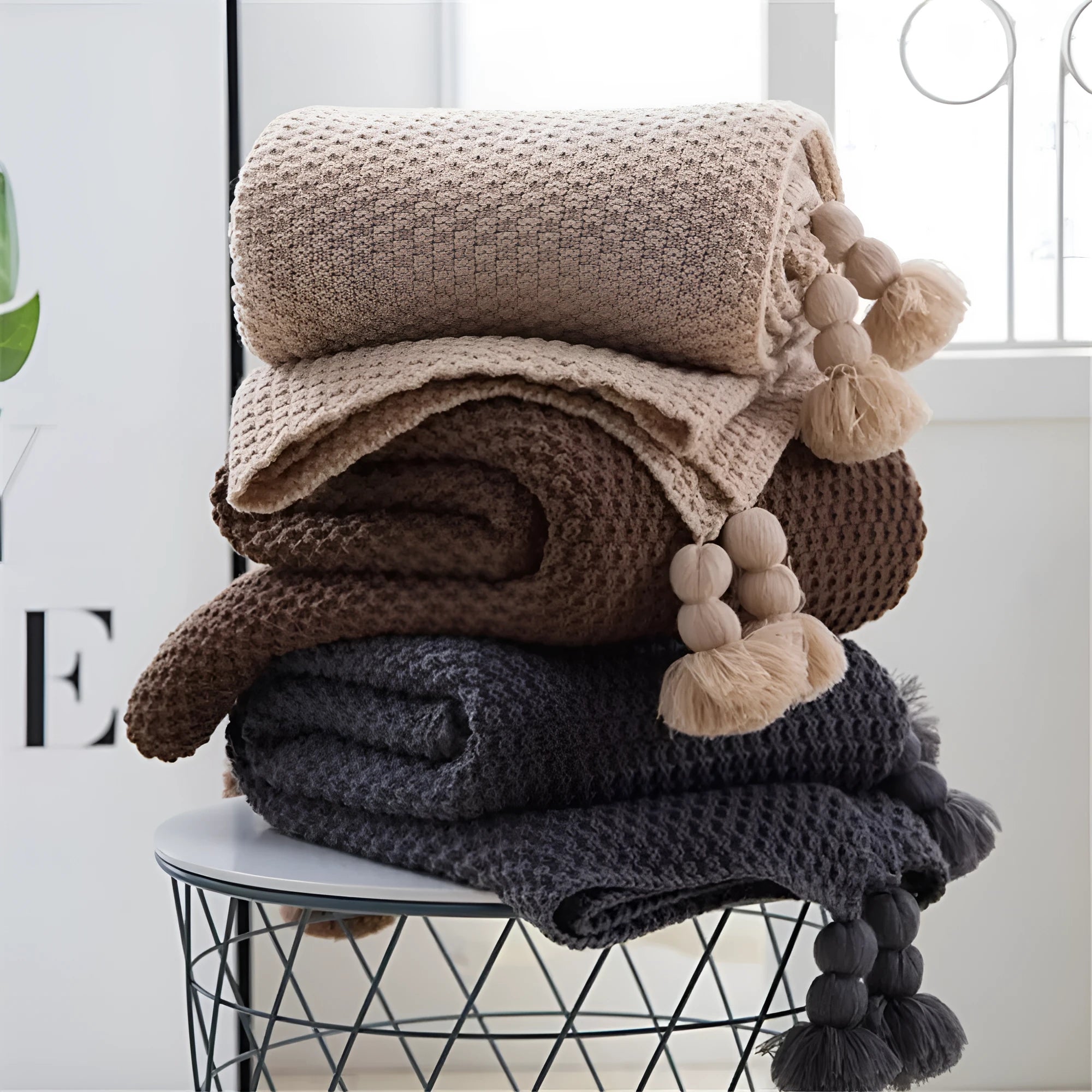 Acrylic knit ball blanket in beige colour, measuring 130 by 170 centimetres, laid flat.