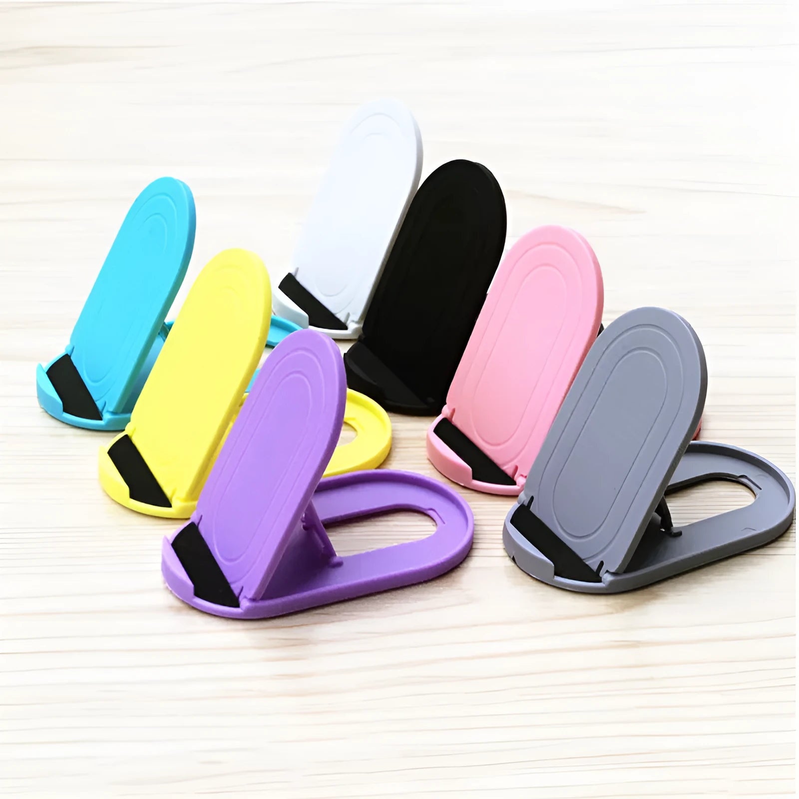 Plastic mobile phone stand bracket in six colour options showing adjustable angle design