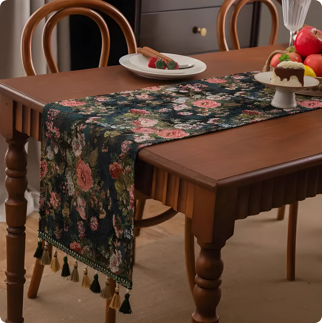Long decorative table runner with tassels on a wooden dining table in a blue ginkgo leaf pattern.
