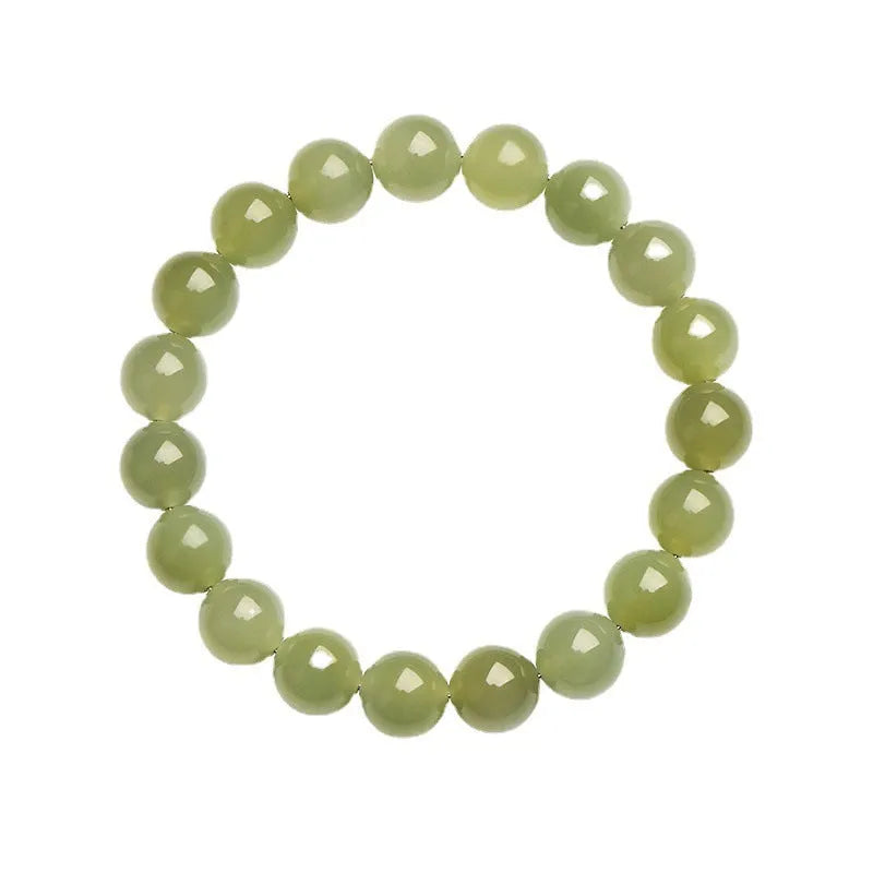 Polished Hetian jade ball bracelet in clear water colour on a wrist, showing spherical beads.