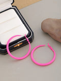 Two tone gradient exaggerated circle earrings on display showing colour transition and hoop shape