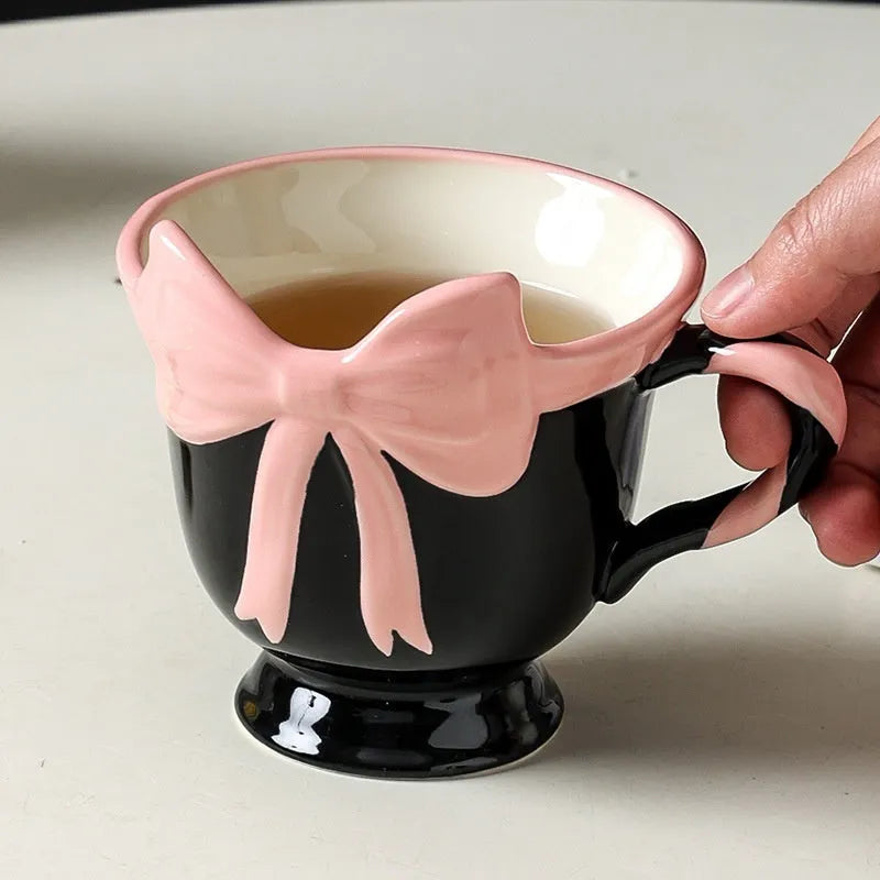 Ceramic mug with girl heart bow decoration in white powder or black pink colour, 301-400ml capacity.