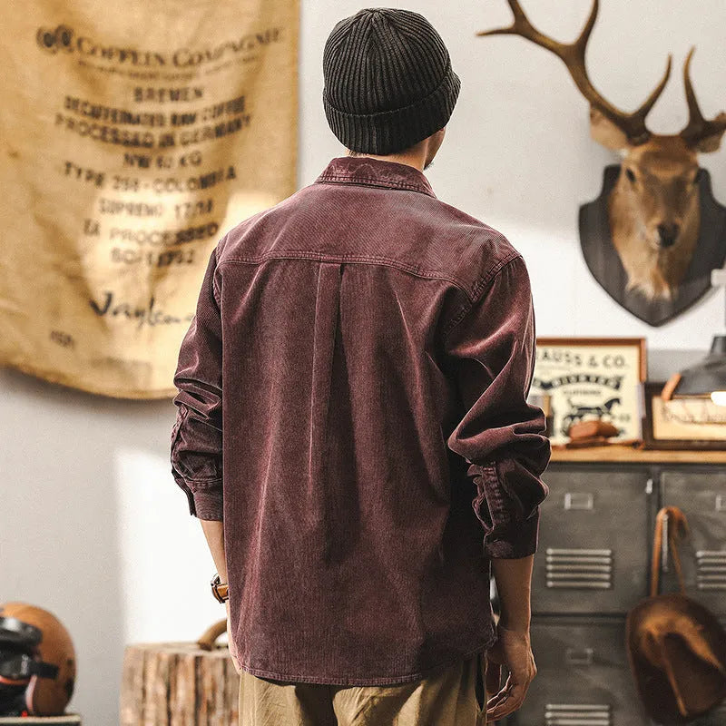 Man wearing a red loose-fit corduroy long sleeve shirt, retro casual style.