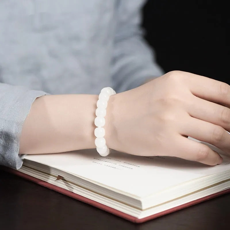 White Hetian jade barrel bead bracelet shown on a wrist, showcasing its unisex casual style.