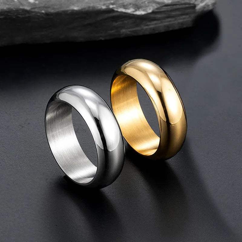 Glossy electroplated titanium steel ring shown in gold, black, and steel colour on a size chart