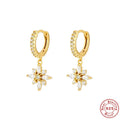 Pair of Sterling Silver snowflake pendant earrings on a yellow or white gold colour background.