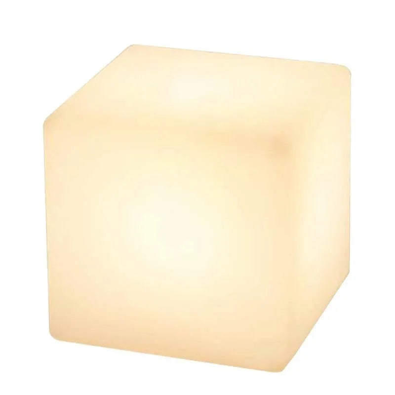 Modern square white LED cube light stool outdoors on a patio.