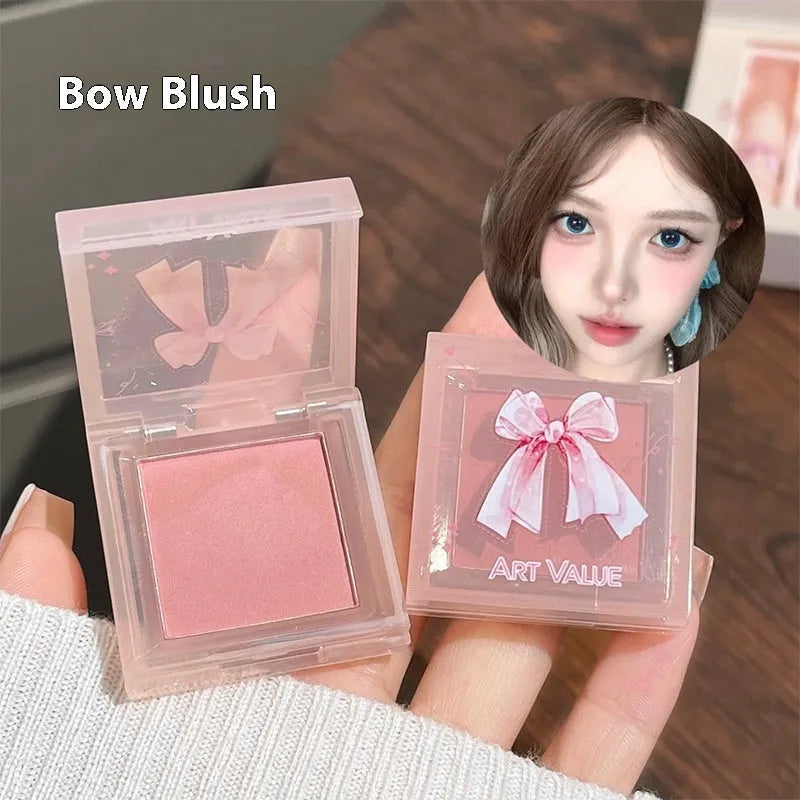 Butterfly Box makeup set showing four pink matte lip muds, powder blusher, and necklace