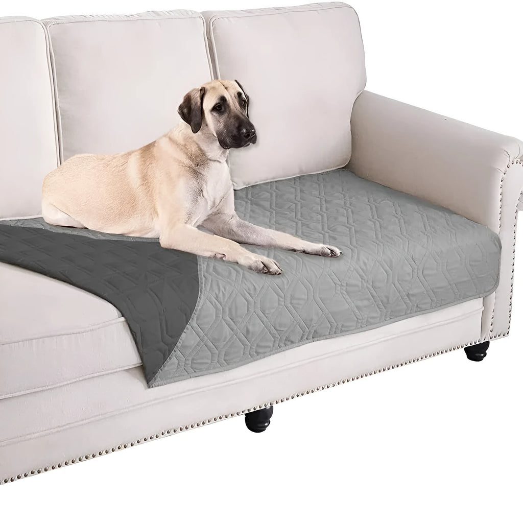 Soft reversible dog blanket couch cover in burgundy with grey reverse side, laid flat on sofa