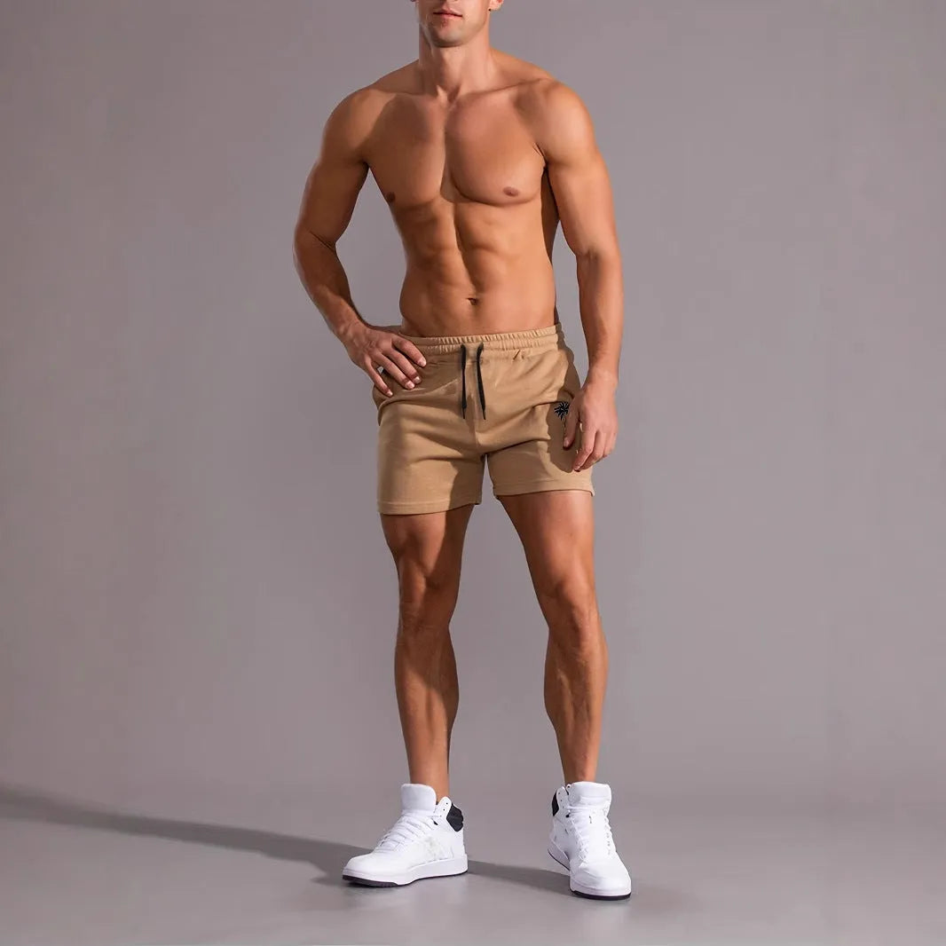 Men's casual khaki polyester sports shorts with coconut print on a model