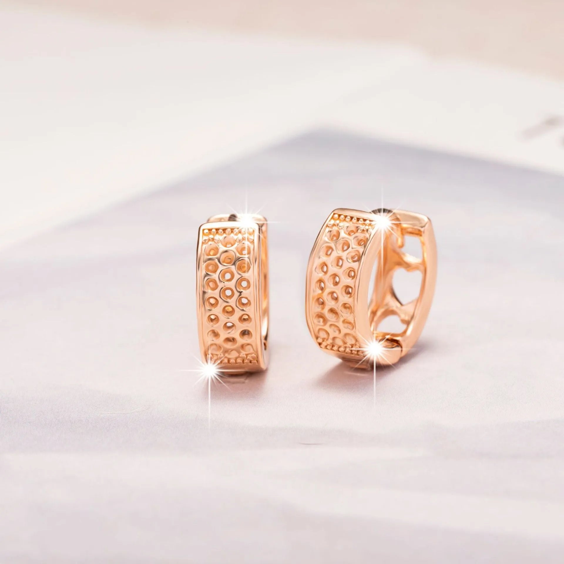 Rose gold hollowed-out heart-shaped circular earrings with electroplated finish