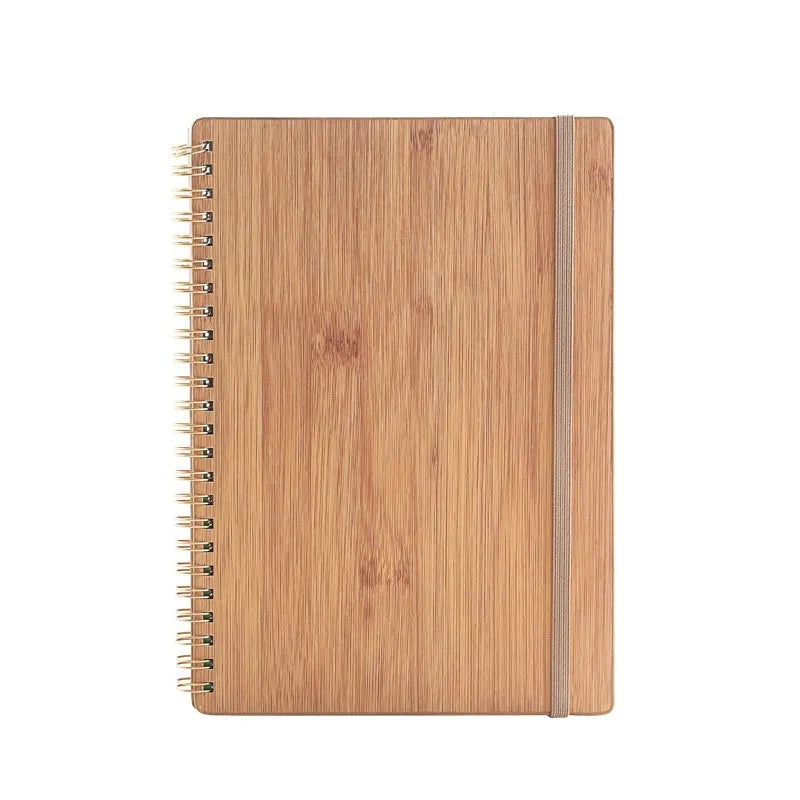 Erasable spiral notebook with stone paper, pen, and cloth on a wooden table