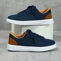 Beige brown platform casual sneaker with cross-belt detail and a low-top silhouette on a white background.