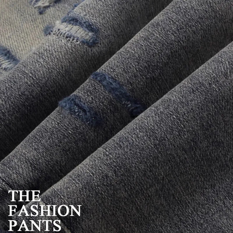 Washed-out old colour slim fit jeans with distressed patches and embroidery detail