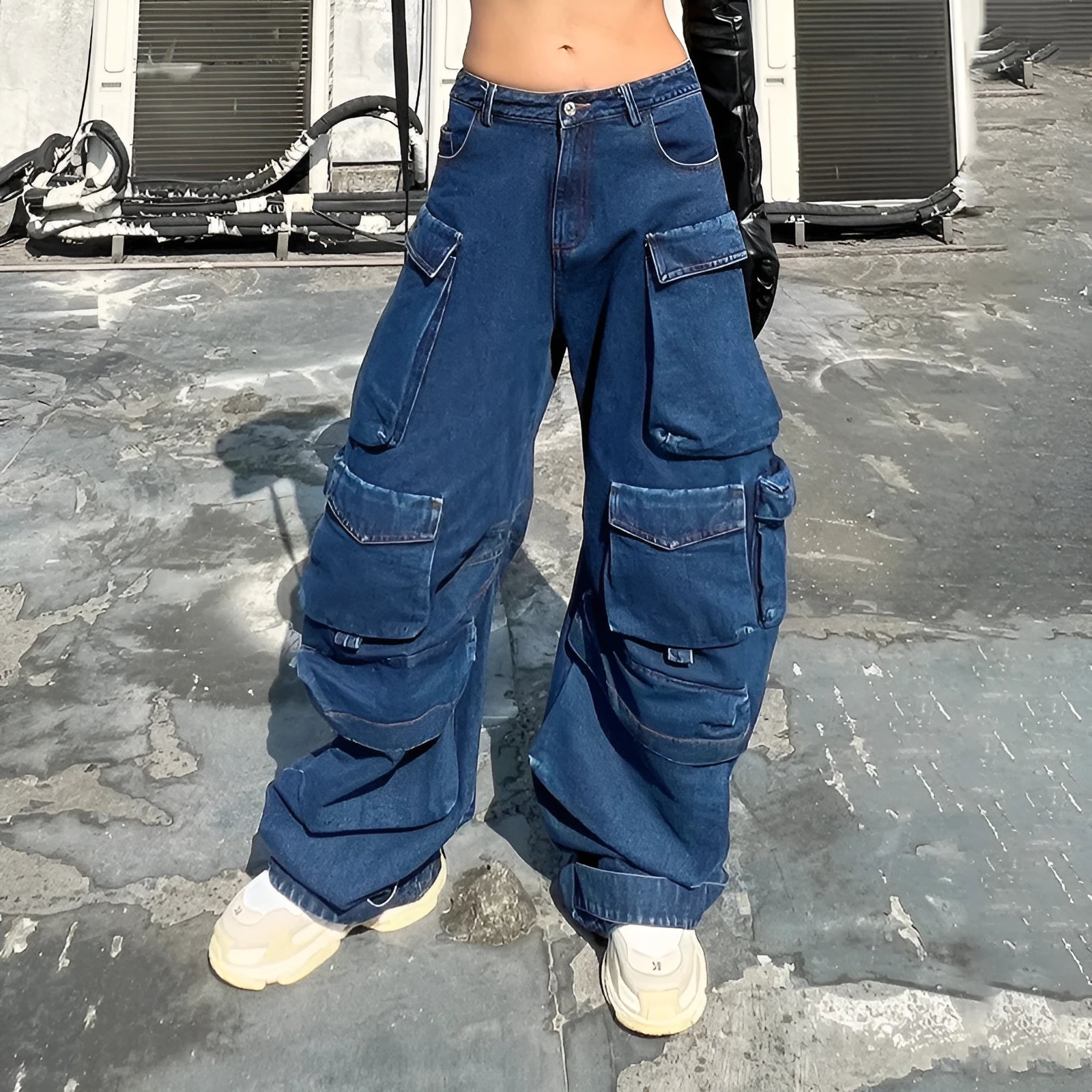 Dark blue distressed wide-leg women's jeans with a high waist and multiple pockets on a hanger.