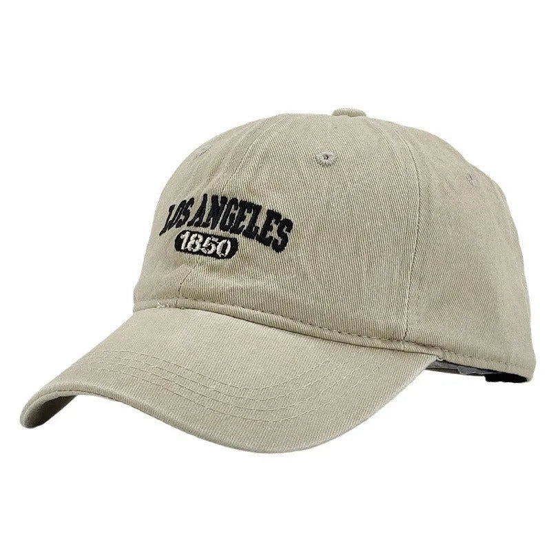 Adjustable peak cap with embroidered letters in distressed retro style, showing conical crown and 7cm brim