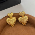Double heart copper earrings with electroplated finish, available as ear clips or ear studs