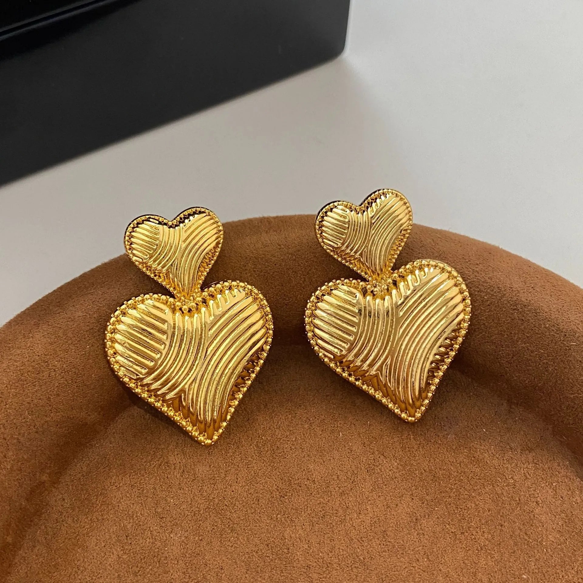 Double heart copper earrings with electroplated finish, available as ear clips or ear studs
