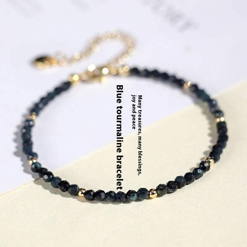 Close-up of a women's blue tourmaline bracelet with 3mm cut beads and spacer bead design.