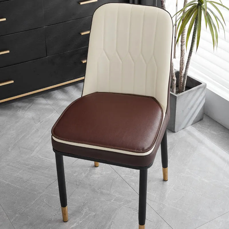 Leather horseshoe-shaped seat cushion on a chair, showing non-slip base and solid colour.