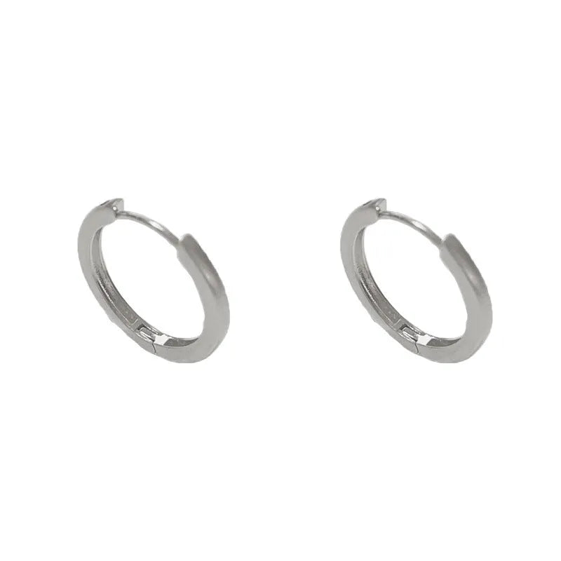 Geometric circle ear clips with gold plating and eyelet detail for women's pierced ears