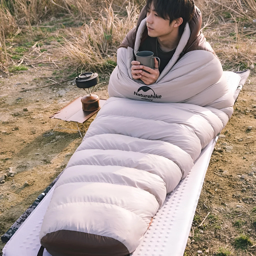 Goose down mummy sleeping bag in snowbird colour with storage bag.