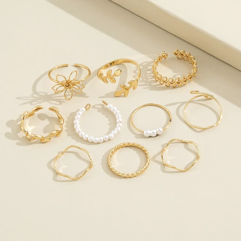 Gold-tone openwork floral ring with a glossy electroplated finish on an alloy band.