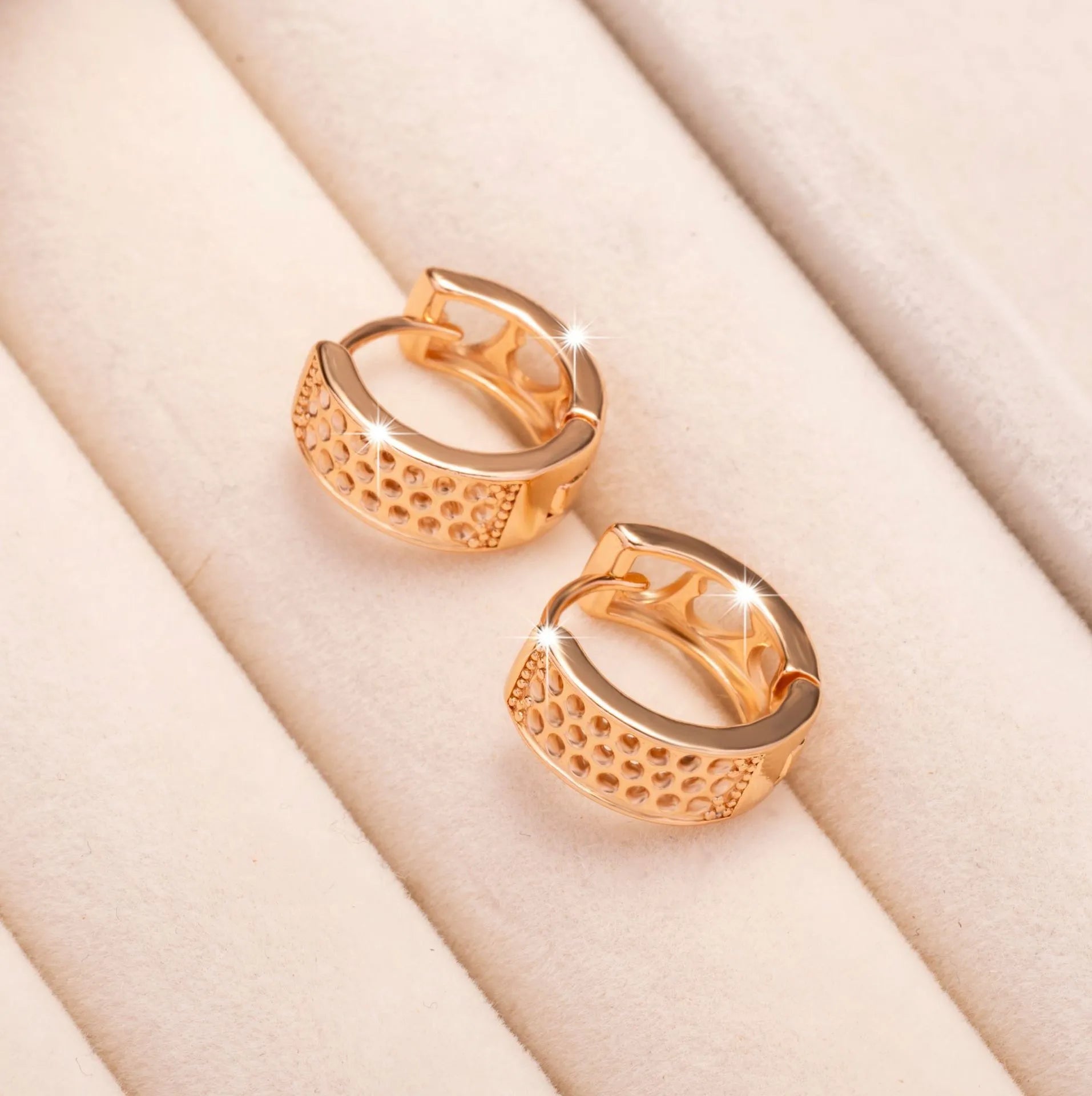 Rose gold hollowed-out heart-shaped circular earrings with electroplated finish