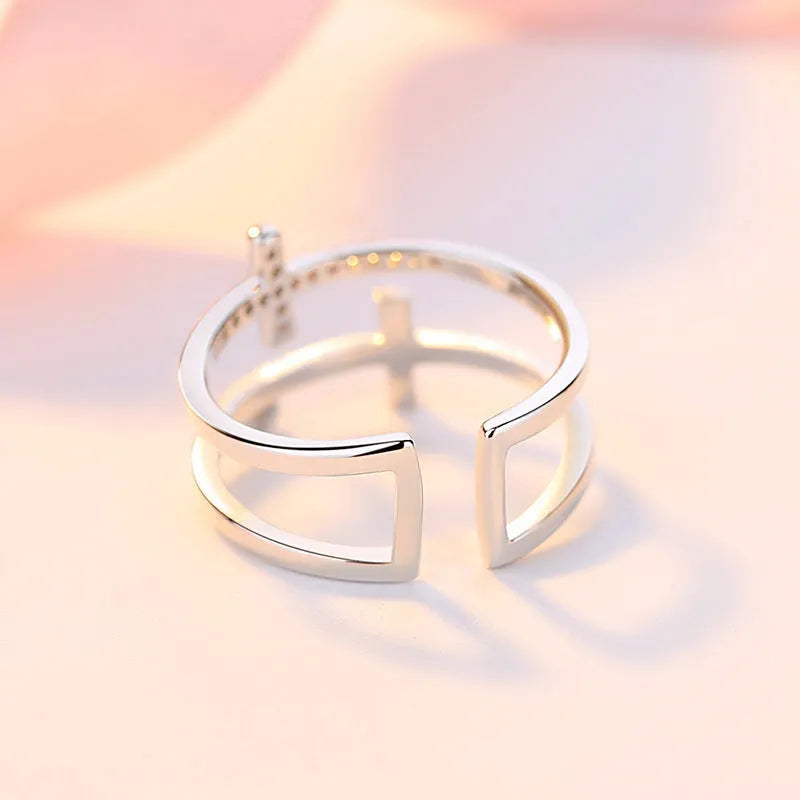 Adjustable copper women's ring featuring a double cross design inlaid with zircon gemstones in a sterling silver setting.