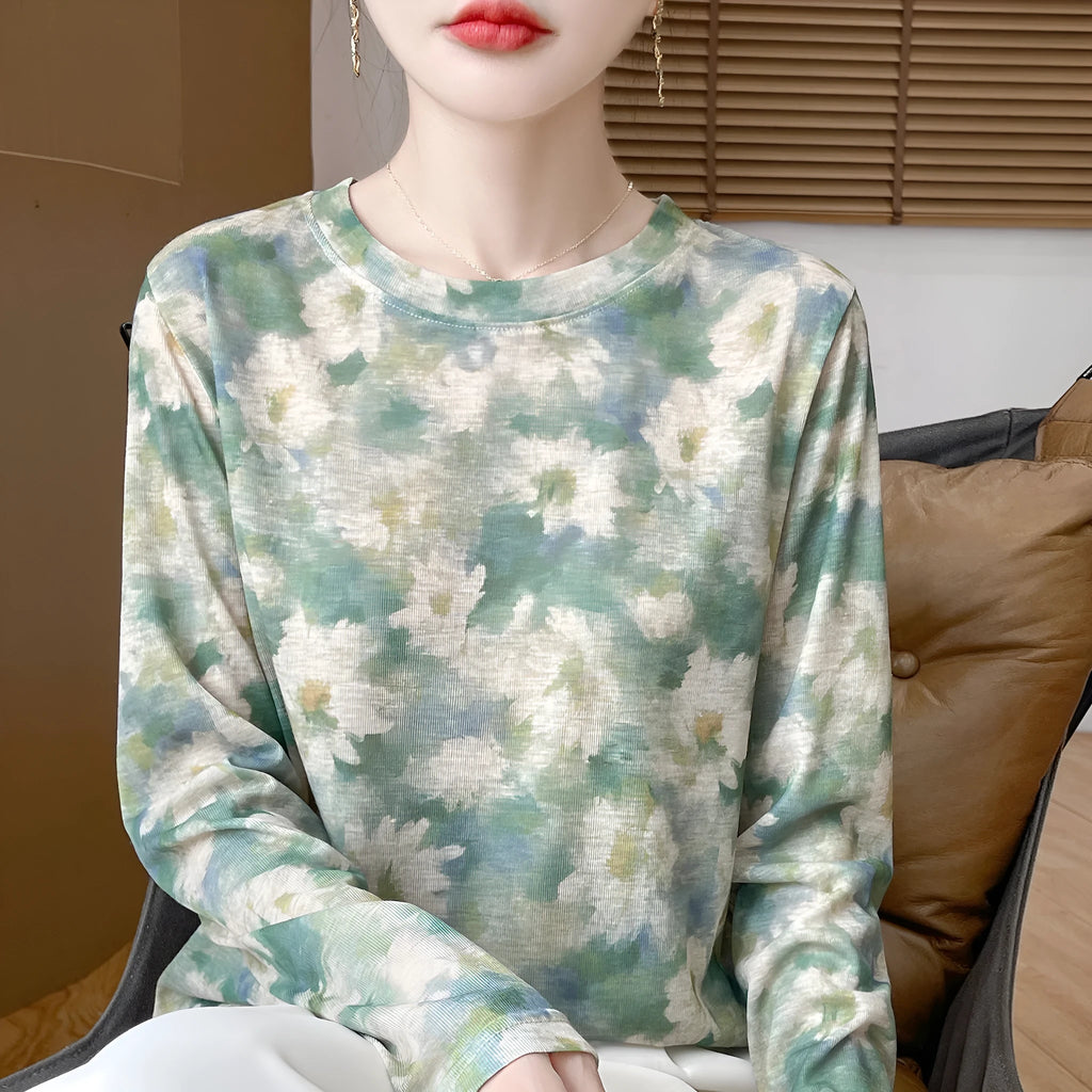 Women's round neck floral print pullover top in Tencel cotton fabric on a hanger.