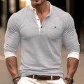 A man wearing a solid colour long sleeve cotton T-shirt in a casual setting.